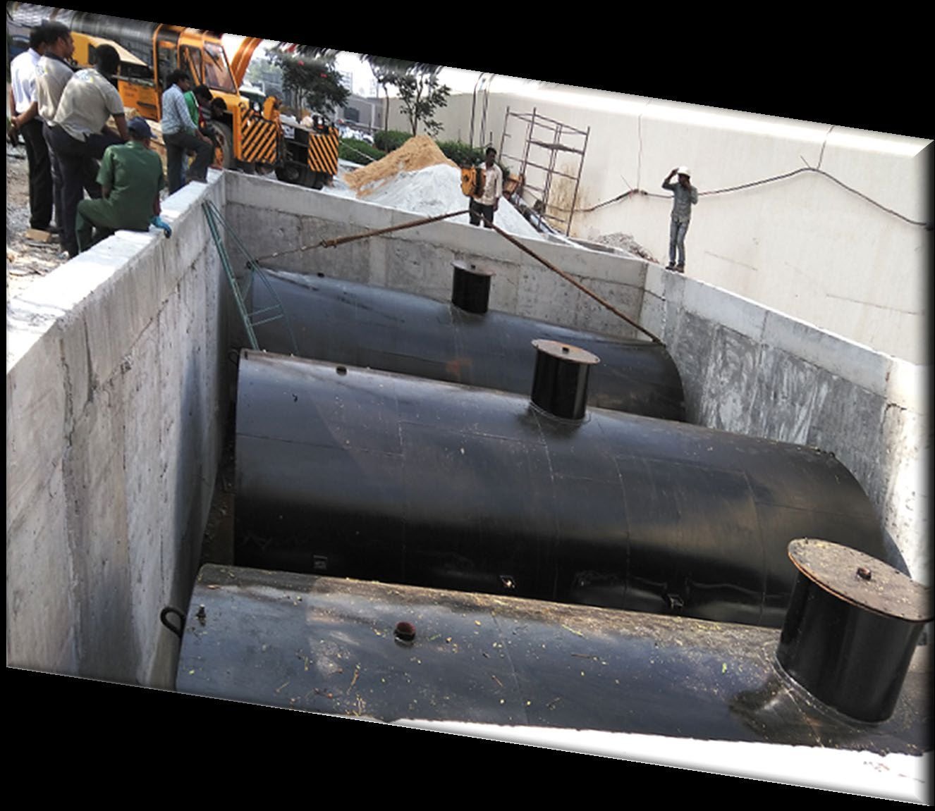 Underground petroleum storage tanks housed in a concrete containment pit at an industrial facility